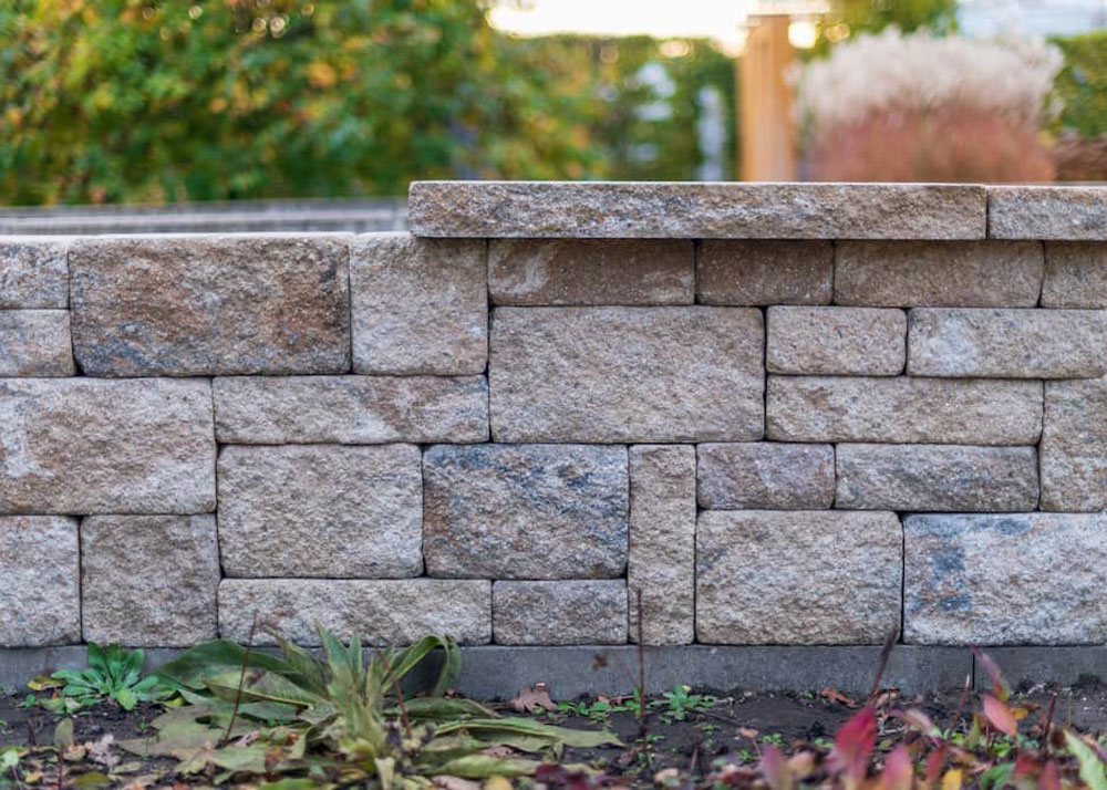Stone retaining wall built for slope stabilization and erosion control